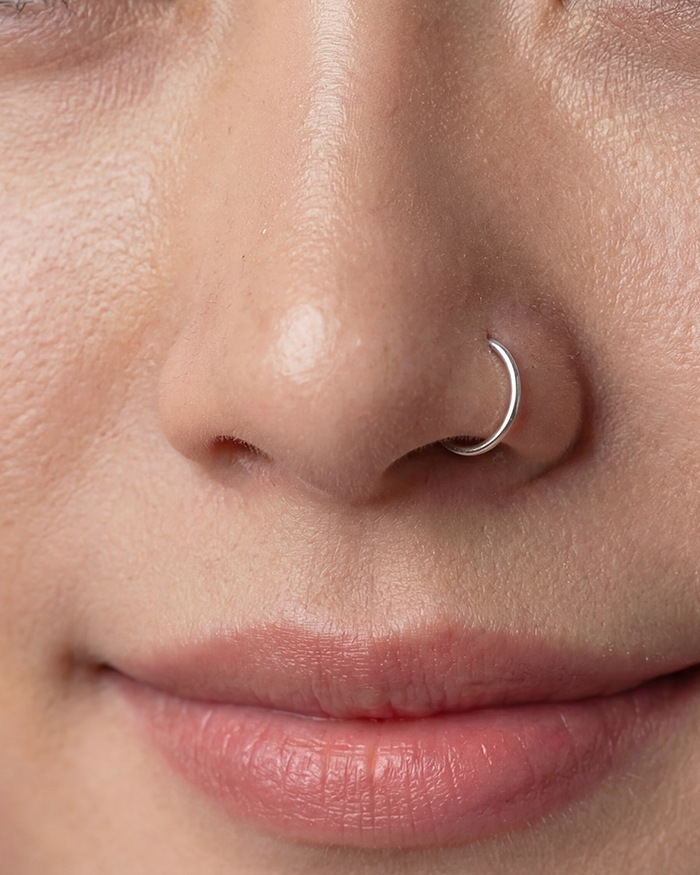 Vela's silver nose hoop, left nostril