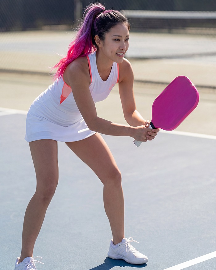 Vela Raye playing pickleball on the court